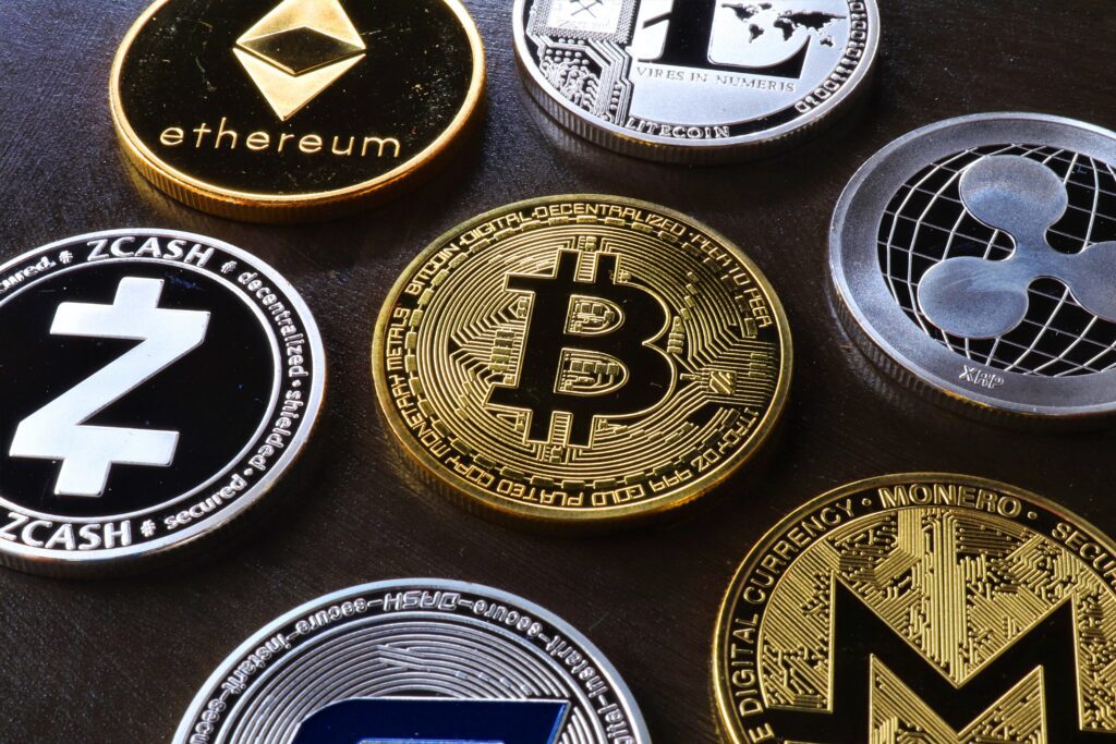 Cryptocurrency coins on a black surface.